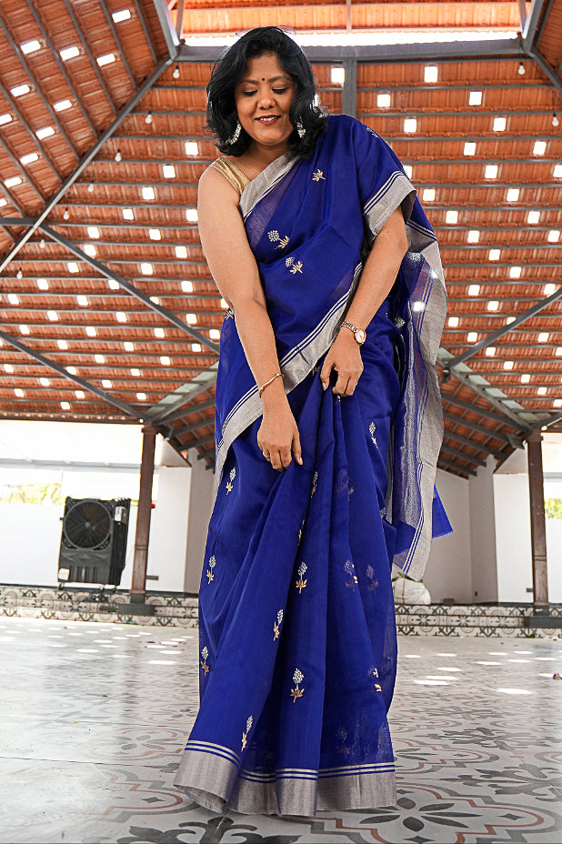 Woman in a blue Chanderi Handloom saree with silver border and bootas