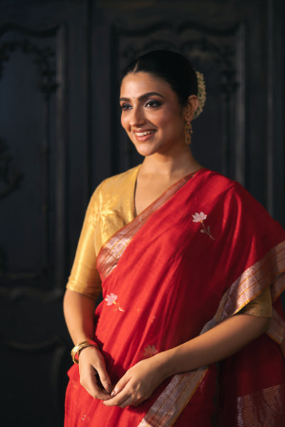 Woman wearing a red Chanderi Handloom saree with flower motifs