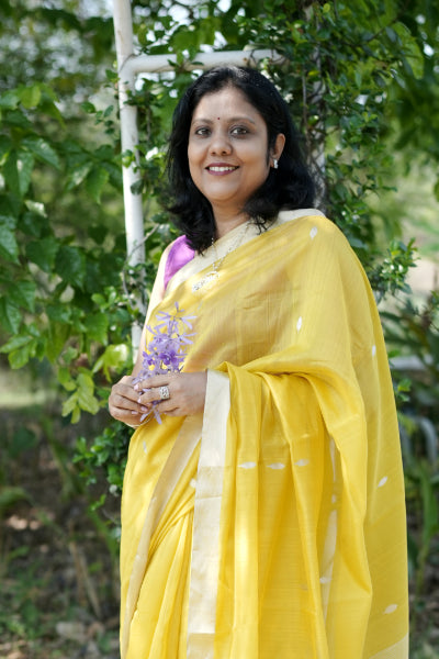 Woman in a yellow Chanderi Handloom saree in outdoors