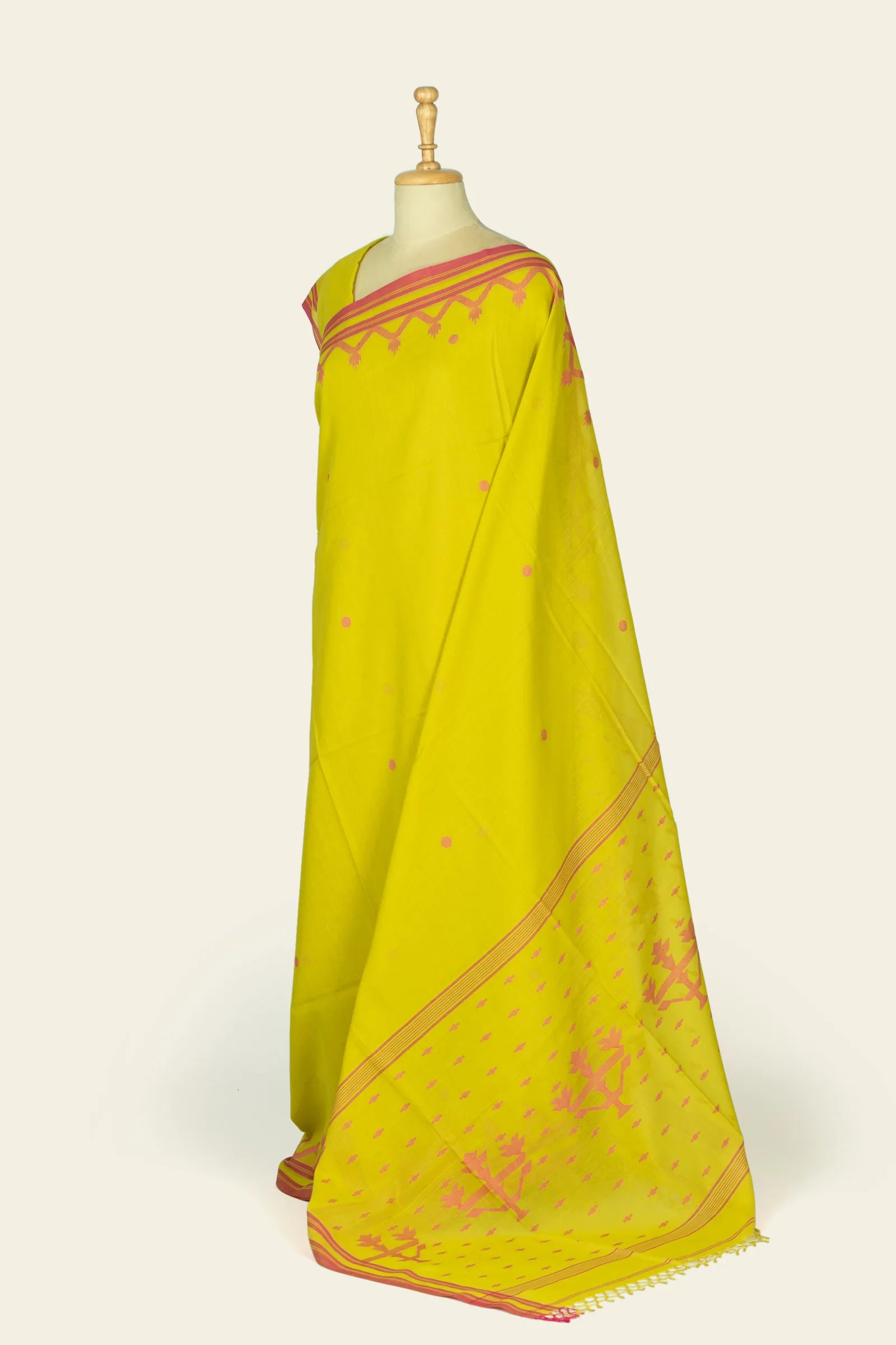 Side view of the saree on a mannequin showing the lower half and pallu spread, revealing a larger area of the pink patterned pallu and border.