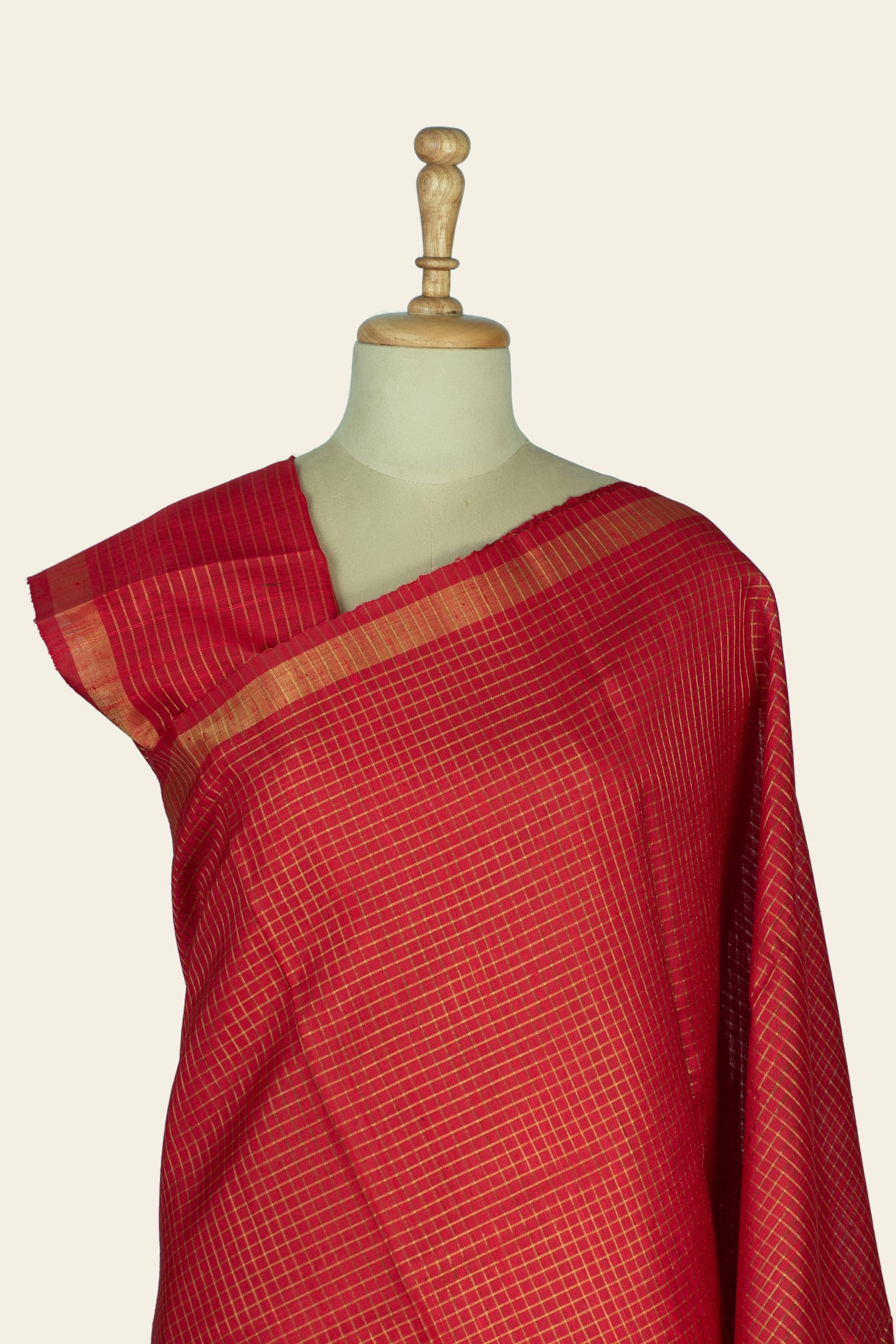 Close frontal view of the upper saree showing the checked pattern and narrow gold border along the shoulder.