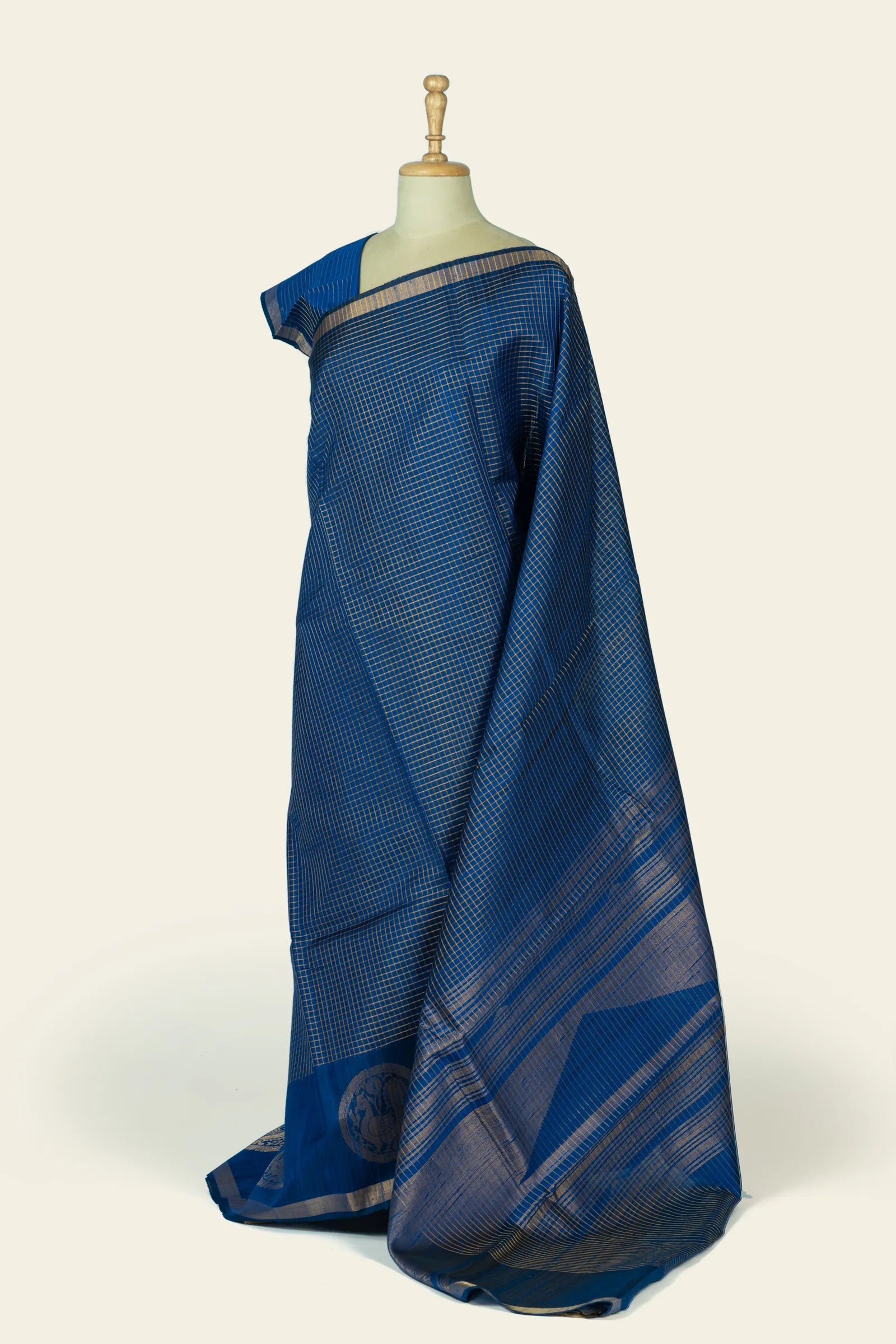 Side view of the saree showing the pallu draped and the checked body flowing into striped pallu lines.