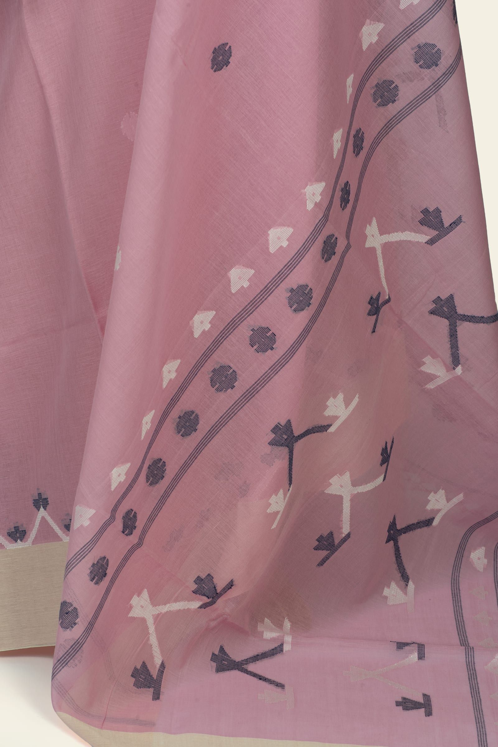 Detailed close-up of the saree border showing woven floral and arrow-like motifs in dark mauve/navy and cream on the pink ground.