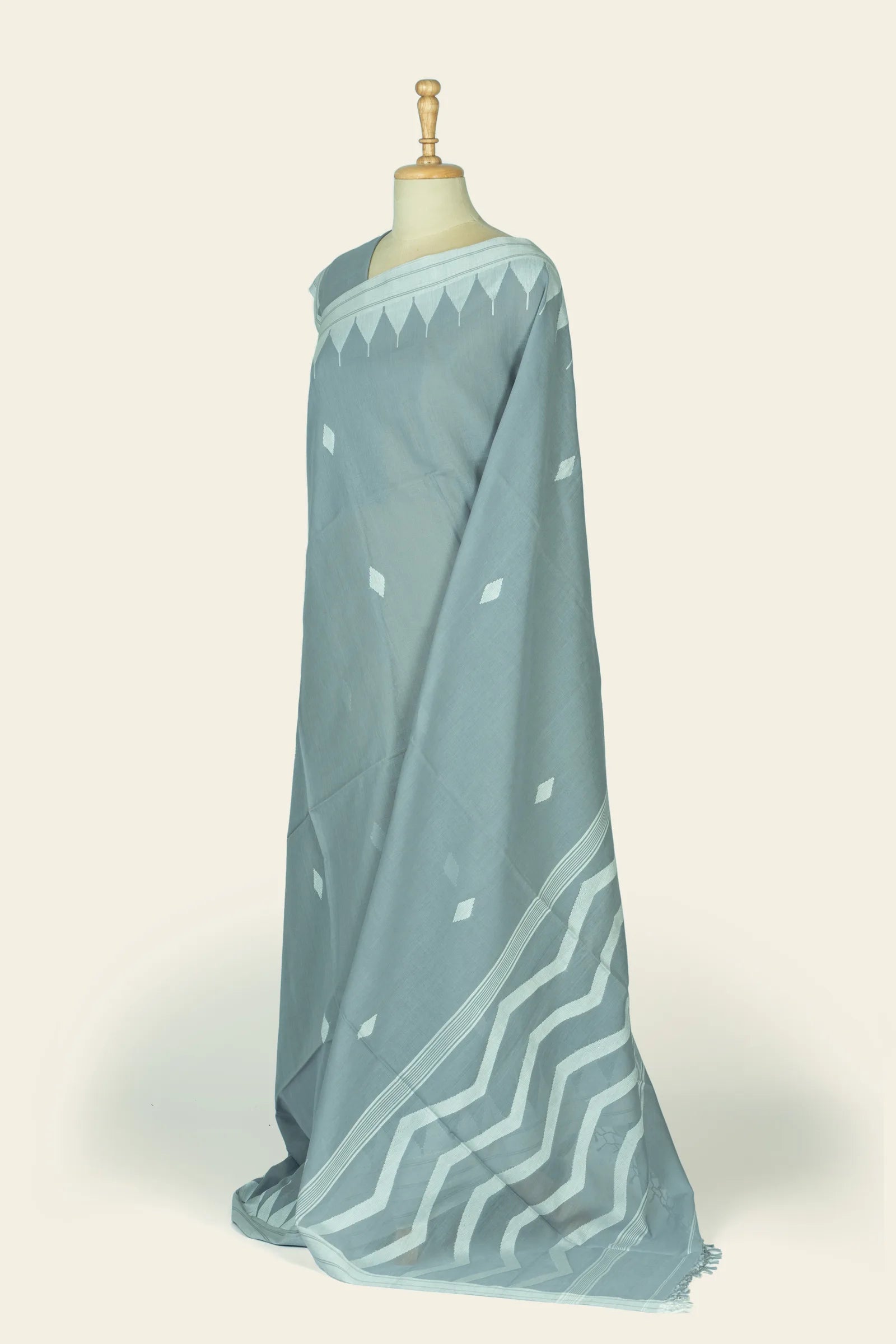 Angled view of the saree highlighting the zigzag chevron pattern on the pallu and scattered diamond motifs on the fall.
