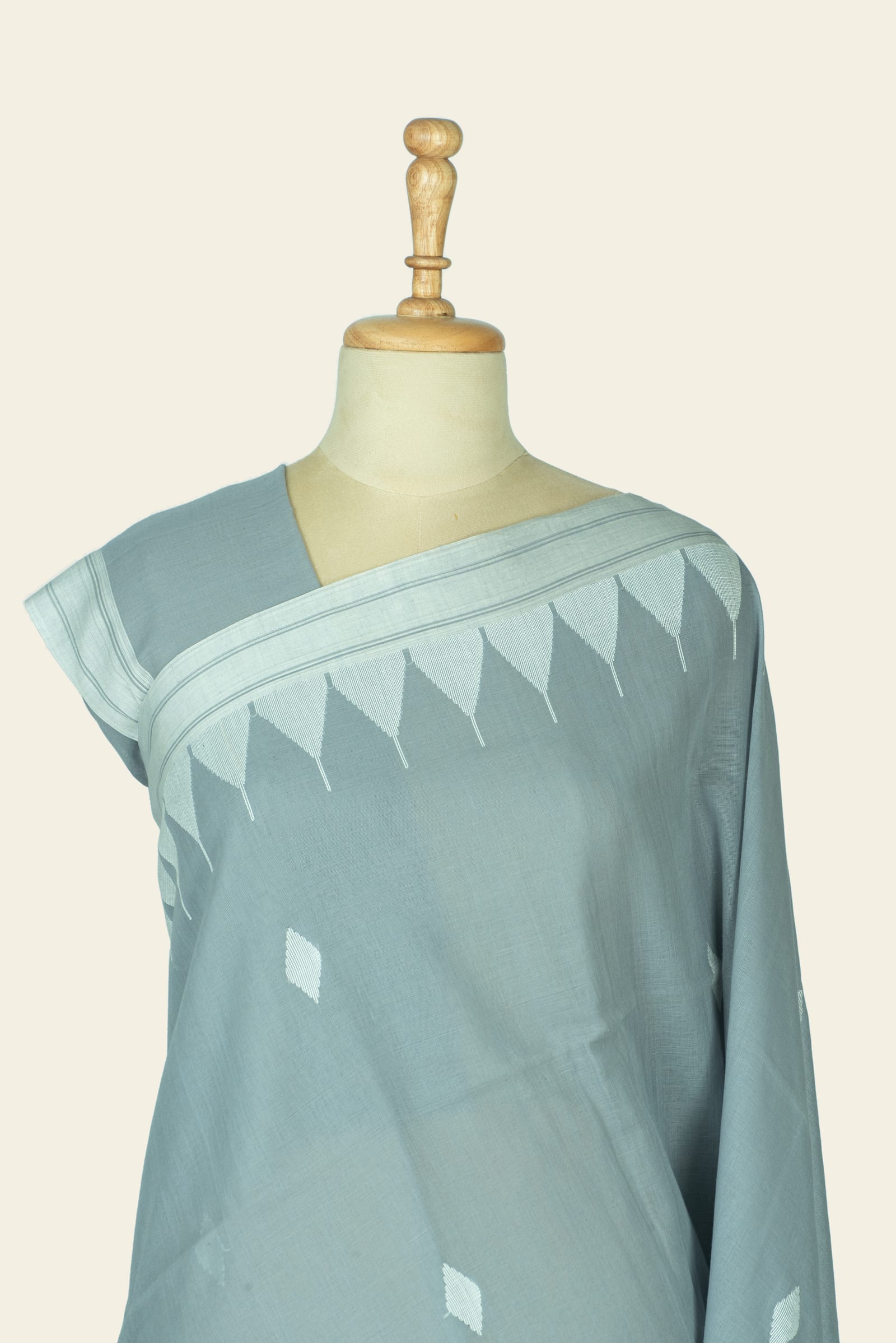 Close upper drape showing triangular motifs repeated along the border and small diamond butis on the front.