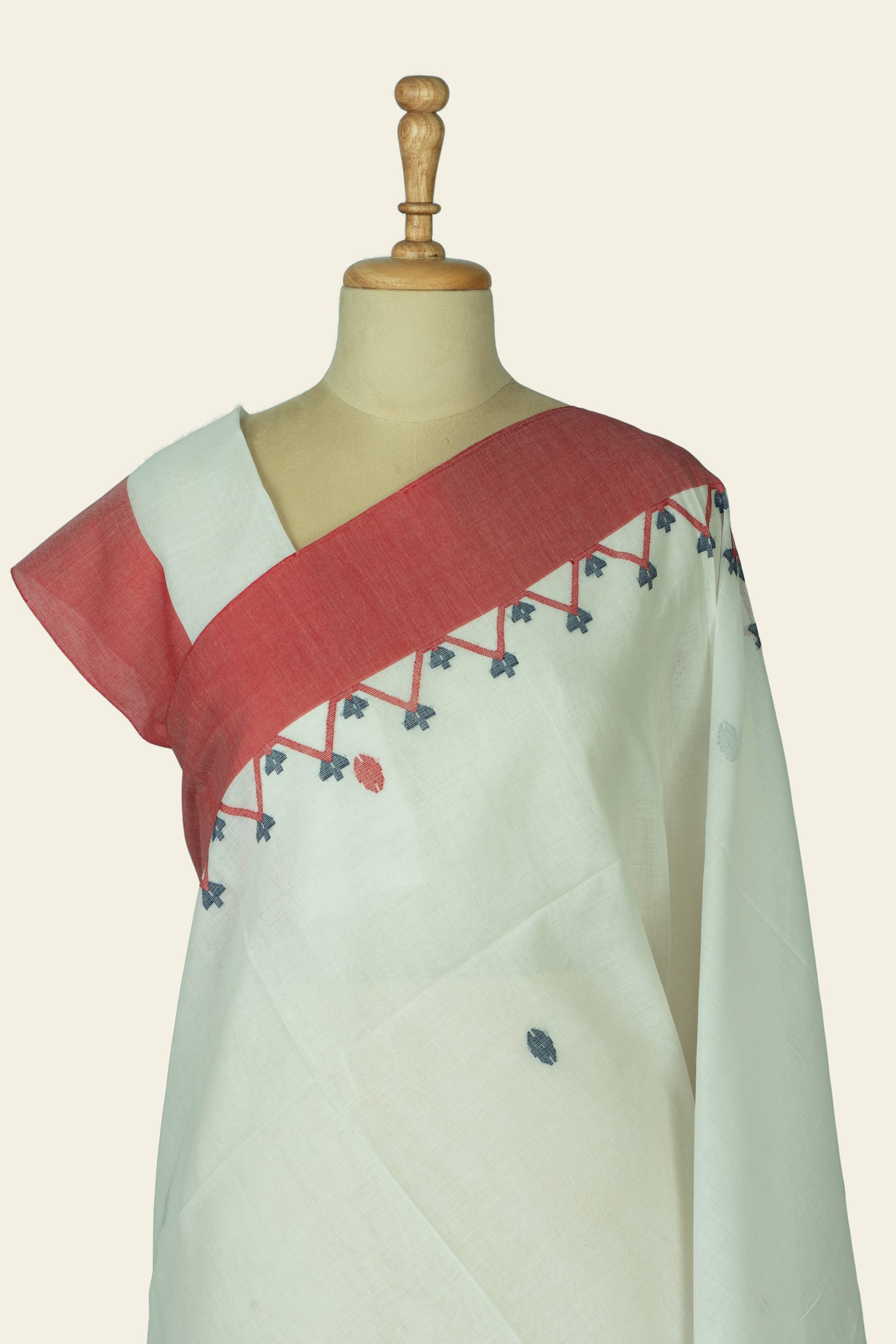 Close view of the blouse area and shoulder showing the coral shoulder border and small triangular motif row beneath it.