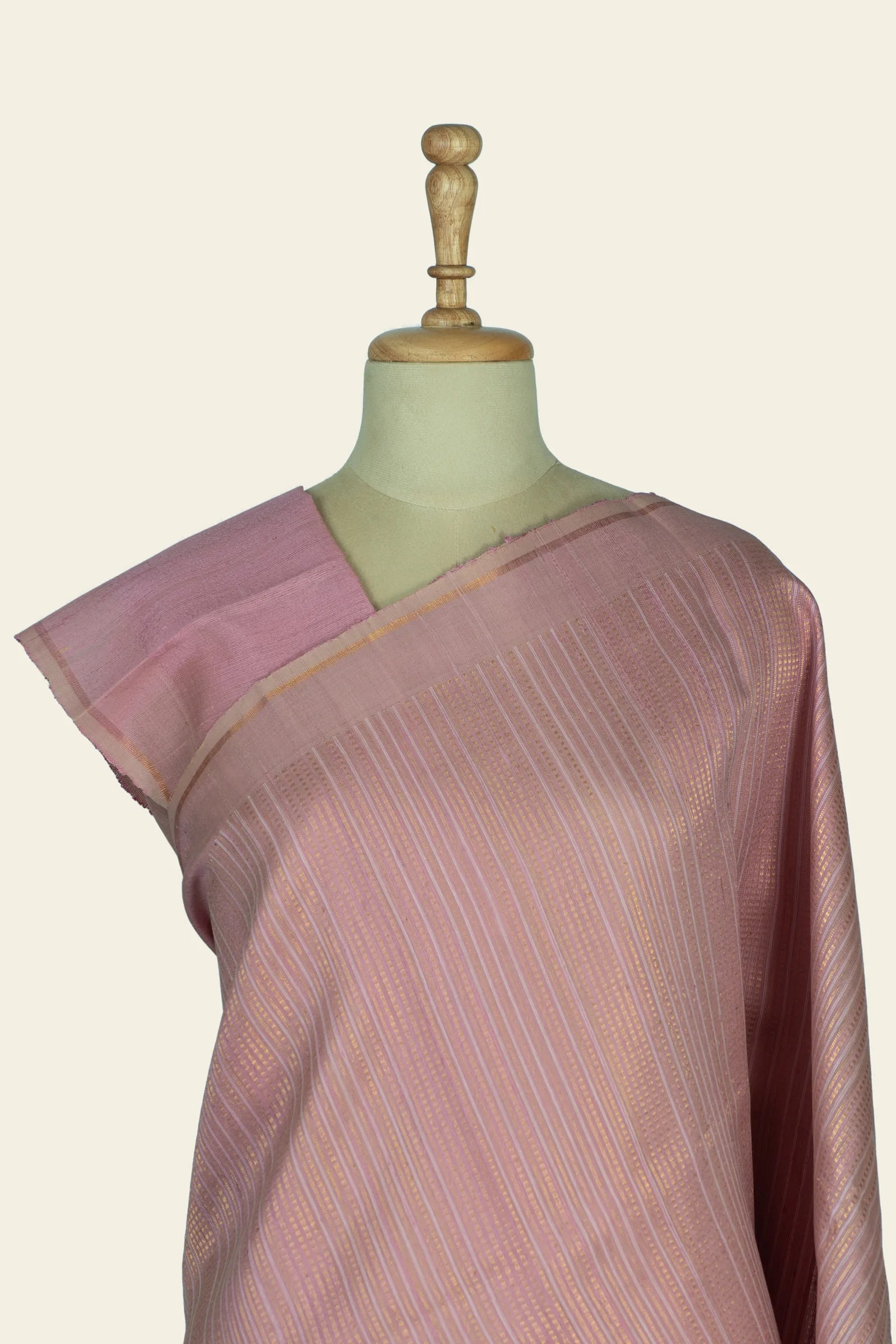 Torso-level close-up of the saree on a mannequin showing blouse edge and striped pattern near the shoulder.