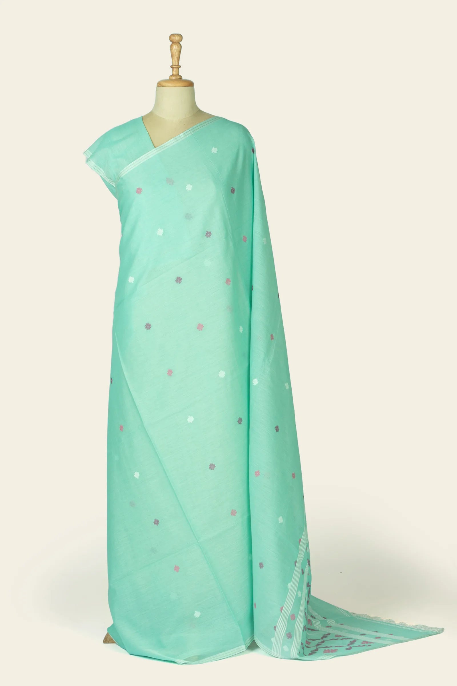 Full-length front drape of a mint green saree with small scattered floral buta and a narrow striped border.
