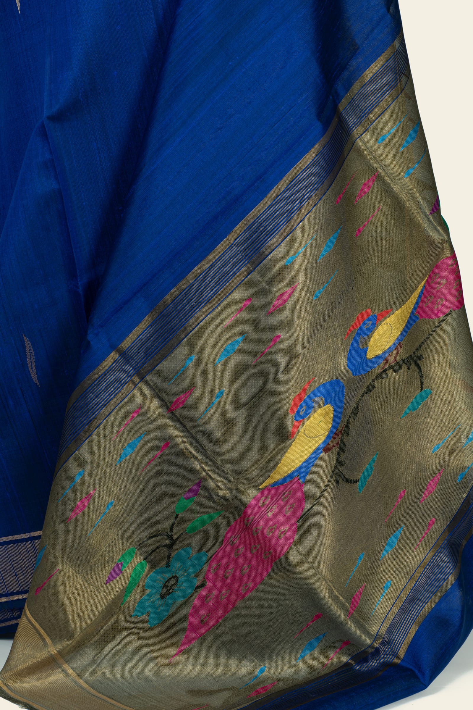 Detailed close-up of the pallu showing an olive-gold woven field with two stylised birds perched among flowers and scattered coloured teardrop motifs.