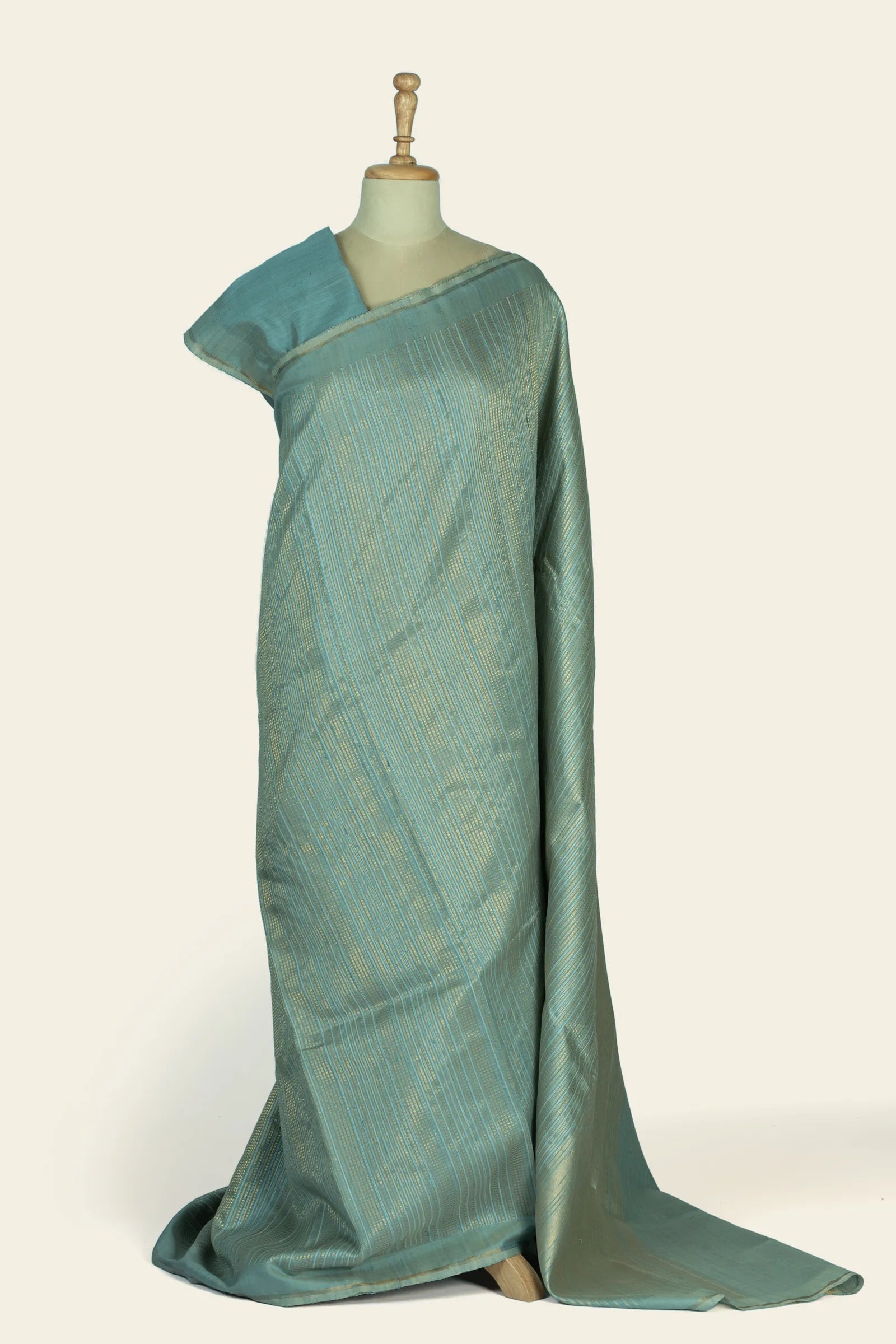 Full-length drape on a mannequin showing a sea green saree with fine vertical gold stripes and a narrow border.