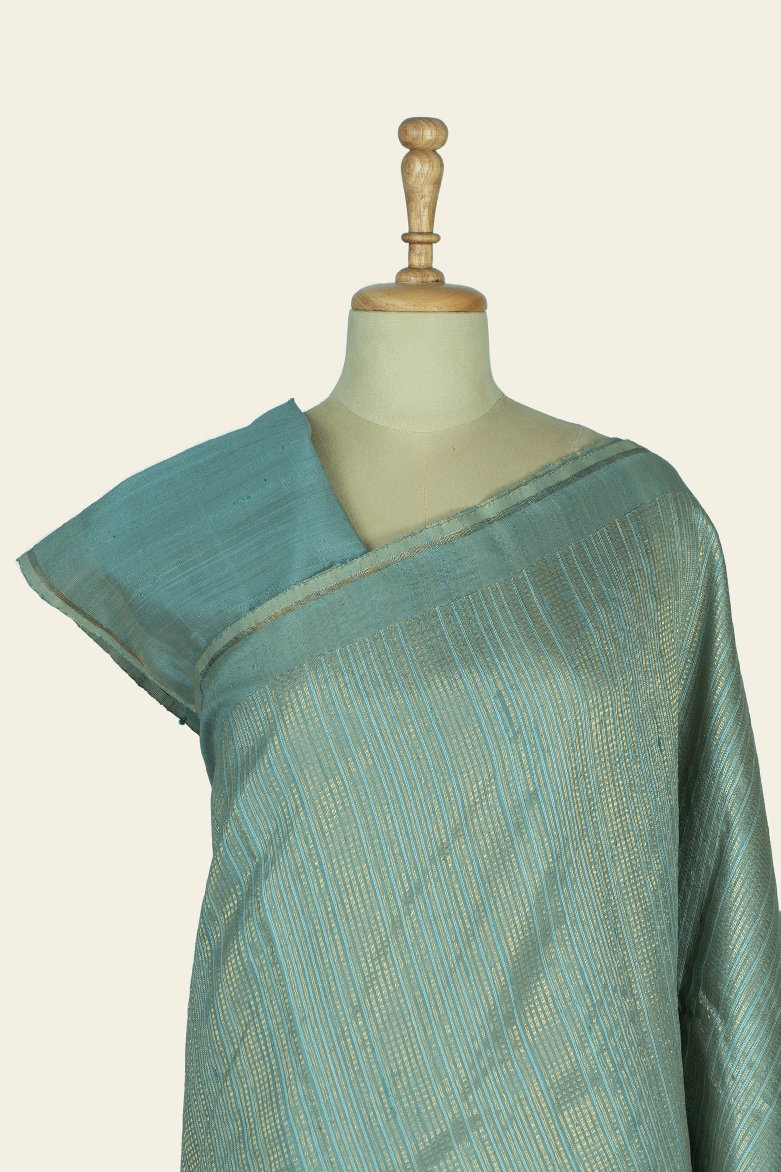 Close front shot of the upper saree and blouse area revealing the stripe pattern and narrow border along the shoulder.