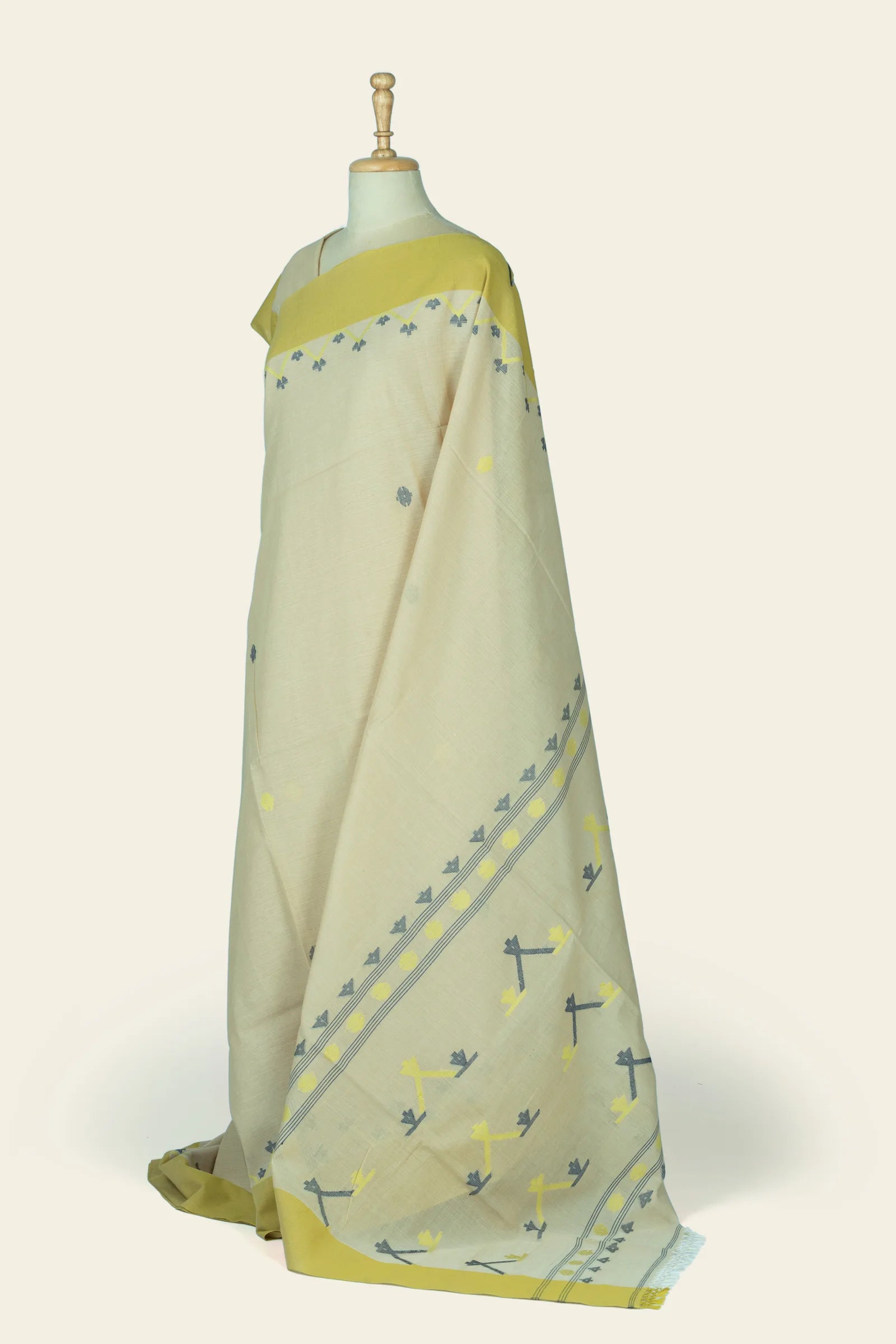 Angled side drape showing the saree's diagonal motif band and scattered geometric motifs on the pallu.